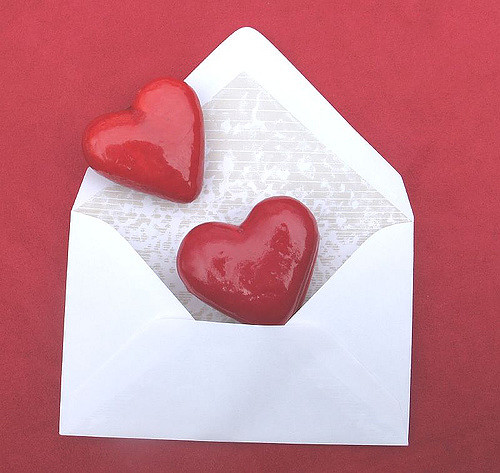 An illustration of two hearts in an envelope.